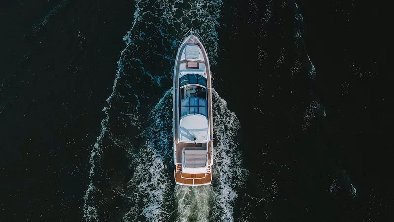 Slide: The Image of Aerial view of 2020 Sunseeker 74 Predator yacht cruising on dark water. - 5