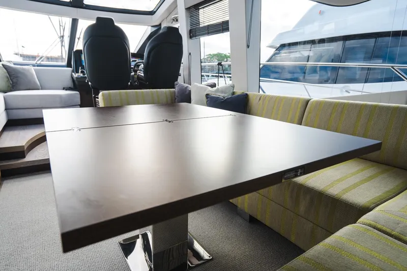 Slide: The Image of Luxurious interior of 2020 Sunseeker 74 Predator yacht with modern seating and table. - 8