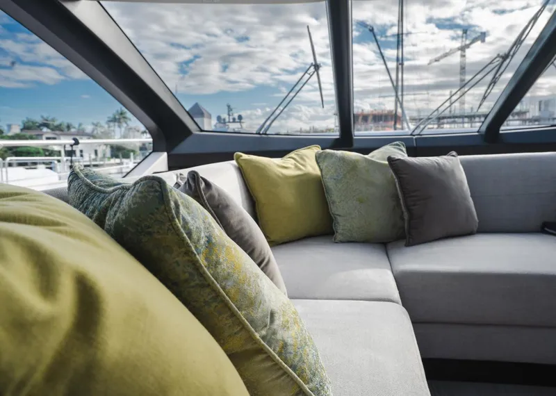 Slide: The Image of Luxurious interior of 2020 Sunseeker 74 Predator yacht with plush cushions and panoramic windows. - 9
