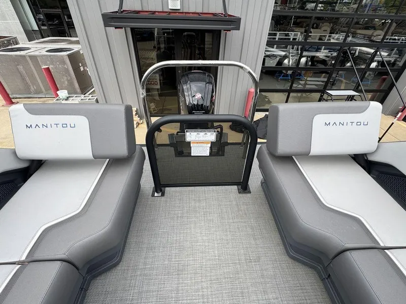 Slide: The Image of 2024 Manitou Cruise 22 Switchback boat interior with gray seating and modern design. - 10