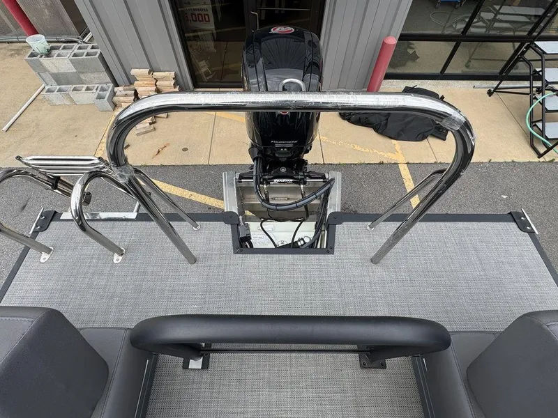 Slide: The Image of 2024 Manitou Cruise 22 Switchback boat deck with motor and railing. - 11