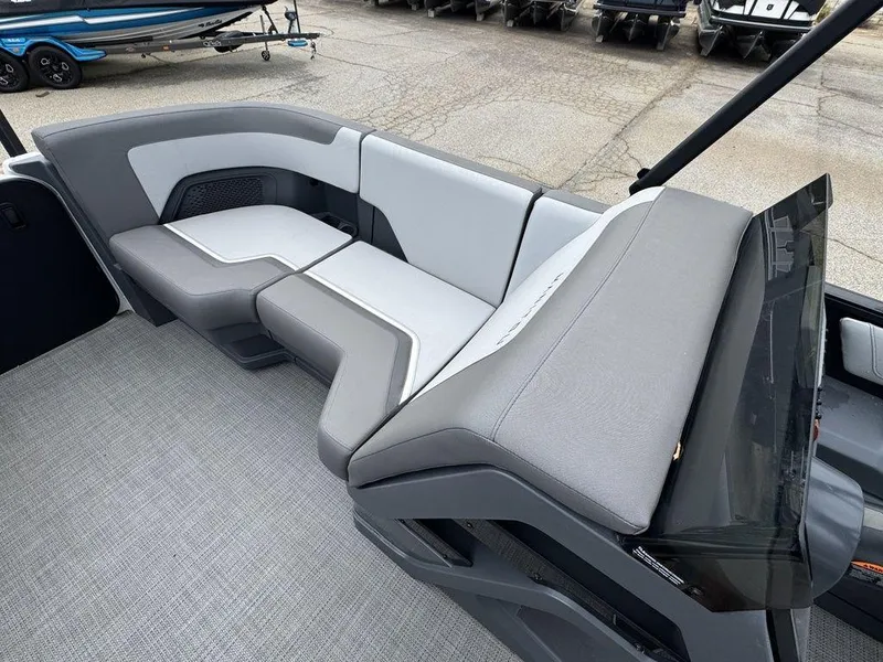 Slide: The Image of 2024 Manitou Cruise 22 Switchback boat interior with gray seating and modern design. - 12