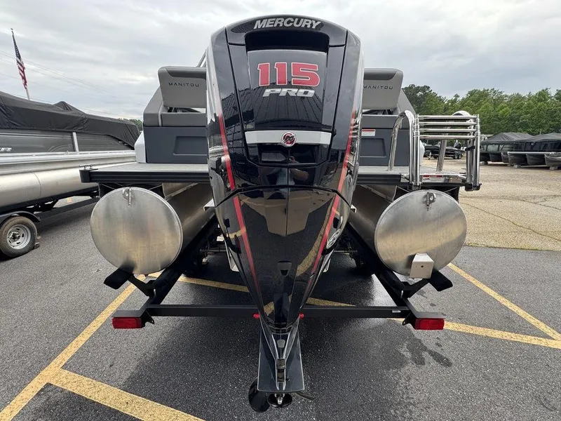 Slide: The Image of 2024 Manitou Cruise 22 Switchback with Mercury 115 Pro motor, rear view in parking lot. - 4