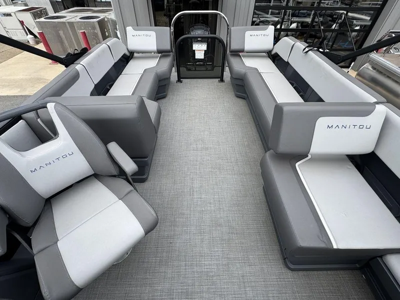 Slide: The Image of 2024 Manitou Cruise 22 Switchback pontoon boat interior with gray seating and spacious layout. - 7