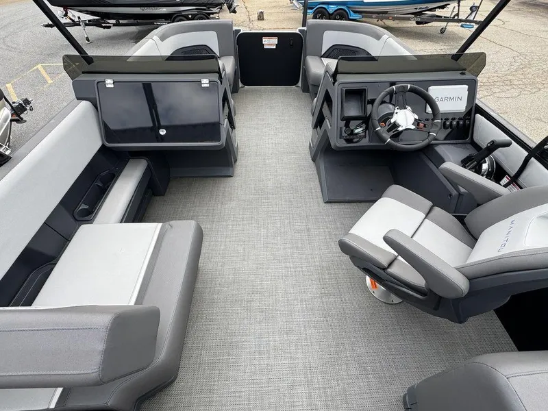 Slide: The Image of 2024 Manitou Cruise 22 Switchback interior with modern seating and steering console. - 8