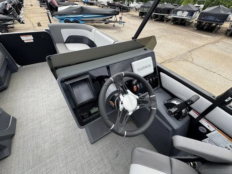 Slide: The Image of 2024 Manitou Cruise 22 Switchback boat dashboard with Garmin navigation system. - 9