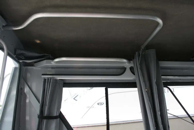 Slide: The Image of Interior view of 2023 Hewescraft 210 Sea Runner ET HT boat with metal framework and curtains. - 10