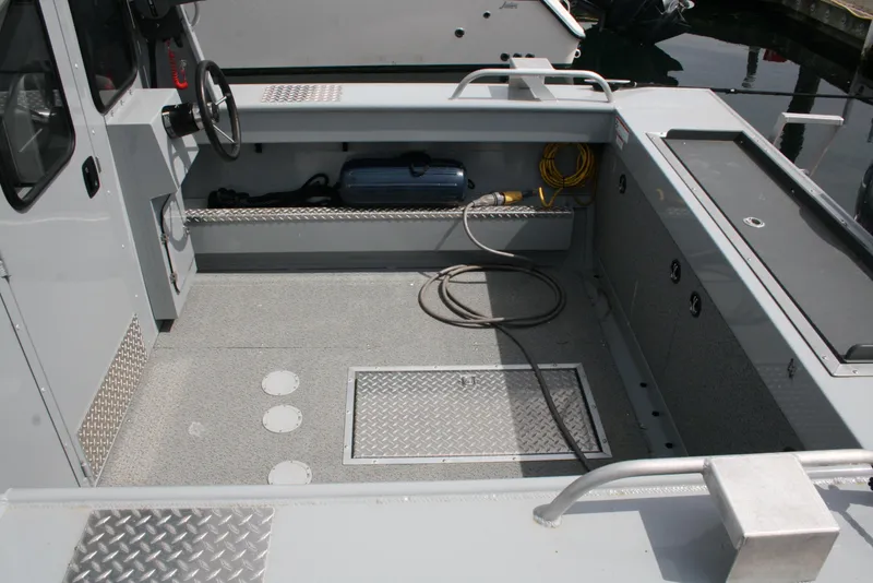 Slide: The Image of 2023 Hewescraft 210 Sea Runner ET HT boat interior with spacious deck and steering console. - 11