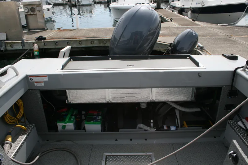 Slide: The Image of 2023 Hewescraft 210 Sea Runner ET HT boat engine compartment at marina. - 12