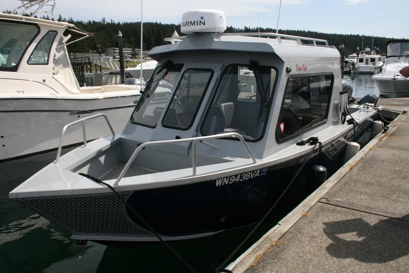 Slide: The Image of 2023 Hewescraft 210 Sea Runner ET HT boat docked at marina. - 2