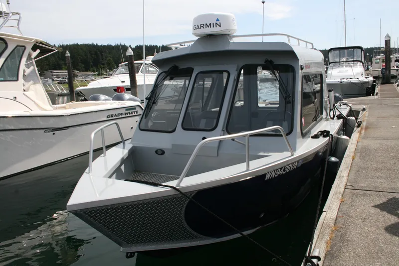 Slide: The Image of 2023 Hewescraft 210 Sea Runner ET HT boat docked at marina. - 3