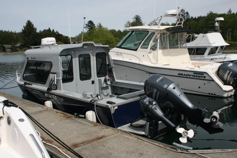 Slide: The Image of 2023 Hewescraft 210 Sea Runner ET HT docked beside other boats. - 4