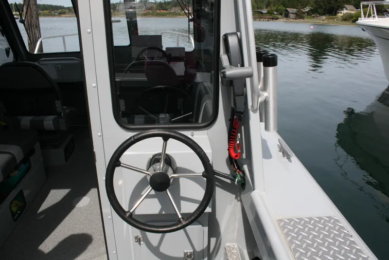Slide: The Image of 2023 Hewescraft 210 Sea Runner ET HT boat helm with steering wheel and controls. - 6