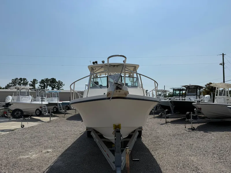 Slide: The Image of 2004 Parker 2510 Walkaround boat on trailer in a marina setting. - 10