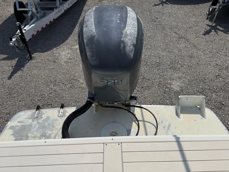 Slide: The Image of Outboard motor on a 2004 Parker 2510 Walkaround boat, gravel background. - 12