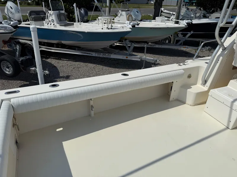 Slide: The Image of 2004 Parker 2510 Walkaround boat deck, clean and spacious, with other boats in the background. - 14