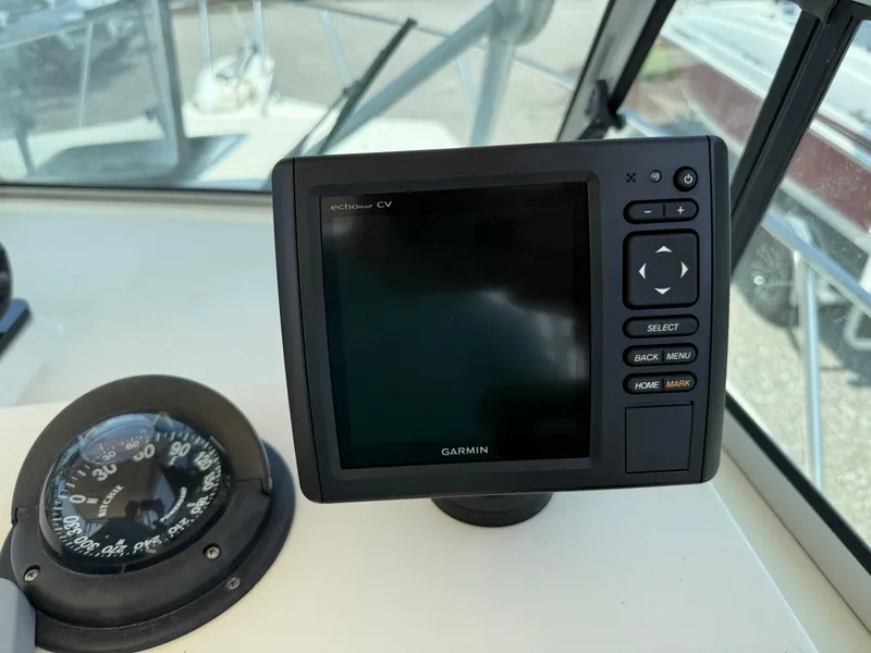 Slide: The Image of Garmin GPS and compass on 2004 Parker 2510 Walkaround boat dashboard. - 19