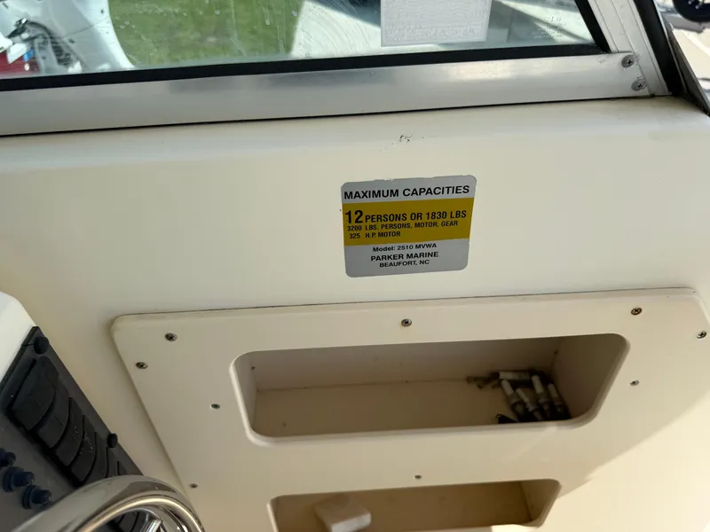 Slide: The Image of 2004 Parker 2510 Walkaround boat capacity label, 12 persons or 1830 lbs. - 20