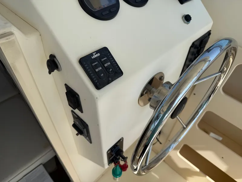 Slide: The Image of 2004 Parker 2510 Walkaround boat steering wheel and control panel close-up. - 21