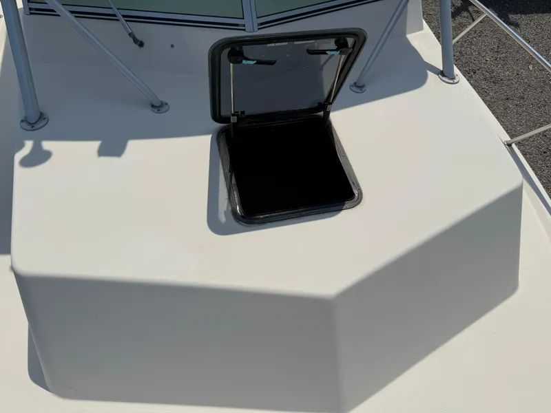 Slide: The Image of 2004 Parker 2510 Walkaround boat deck with open hatch. - 27