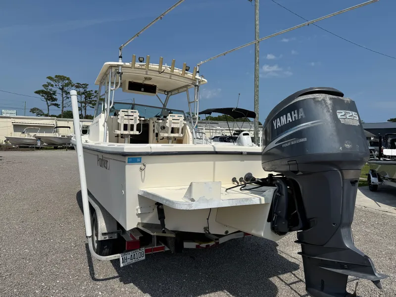 Slide: The Image of 2004 Parker 2510 Walkaround boat with Yamaha 225 outboard motor, parked on gravel lot. - 4