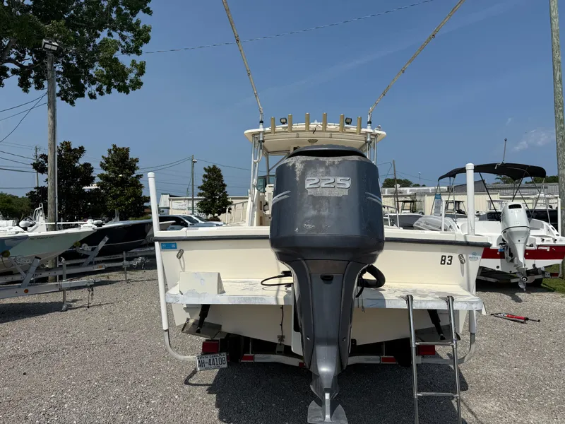 Slide: The Image of 2004 Parker 2510 Walkaround boat with 225 horsepower engine, parked on gravel lot. - 5