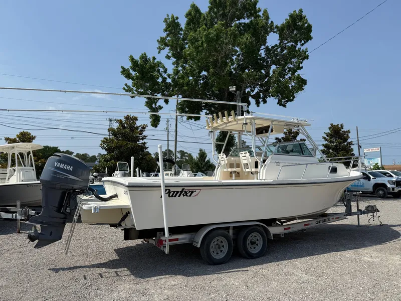 Slide: The Image of 2004 Parker 2510 Walkaround boat on trailer with Yamaha outboard motor, parked outdoors. - 7