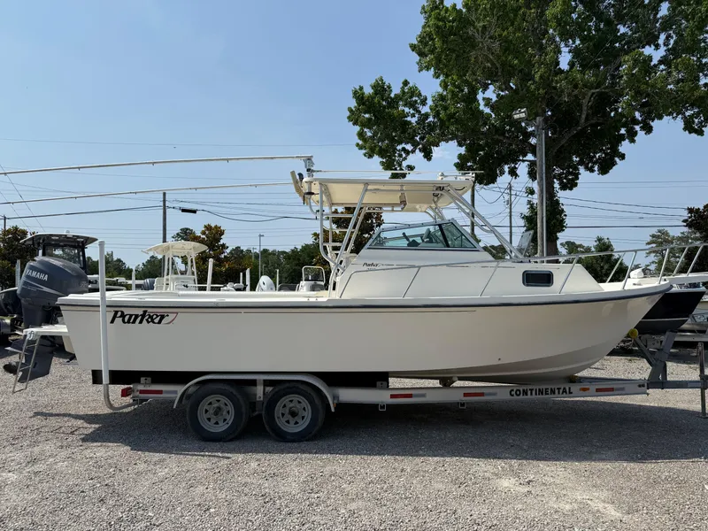 Slide: The Image of 2004 Parker 2510 Walkaround boat on trailer, parked outdoors, side view. - 8