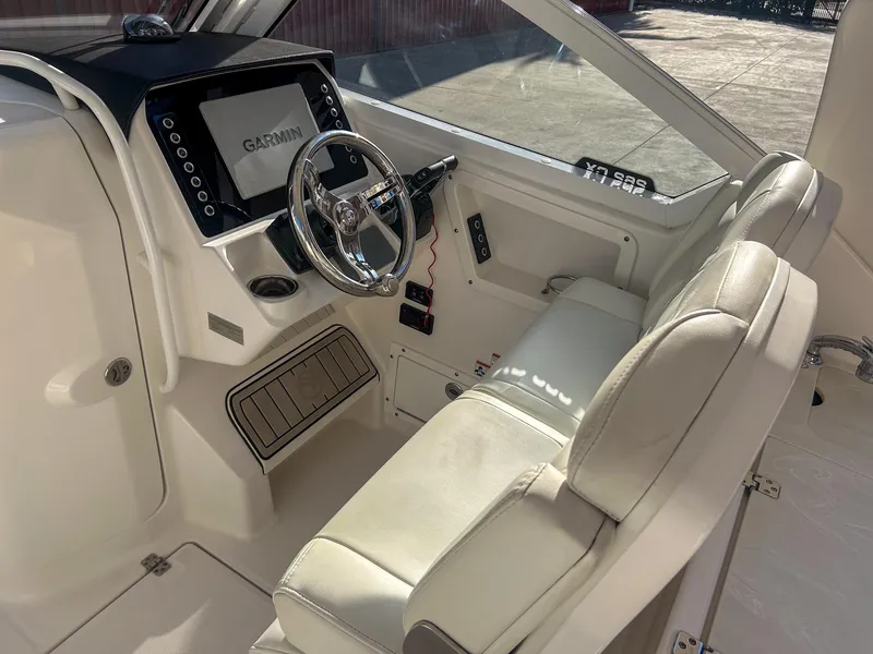 Slide: The Image of Interior of 2020 Edgewater 262 CX boat with Garmin navigation system and white seating. - 10