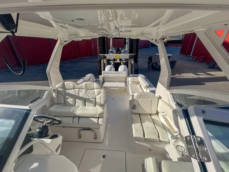 Slide: The Image of 2020 Edgewater 262 CX boat interior with white seating and steering wheel. - 13