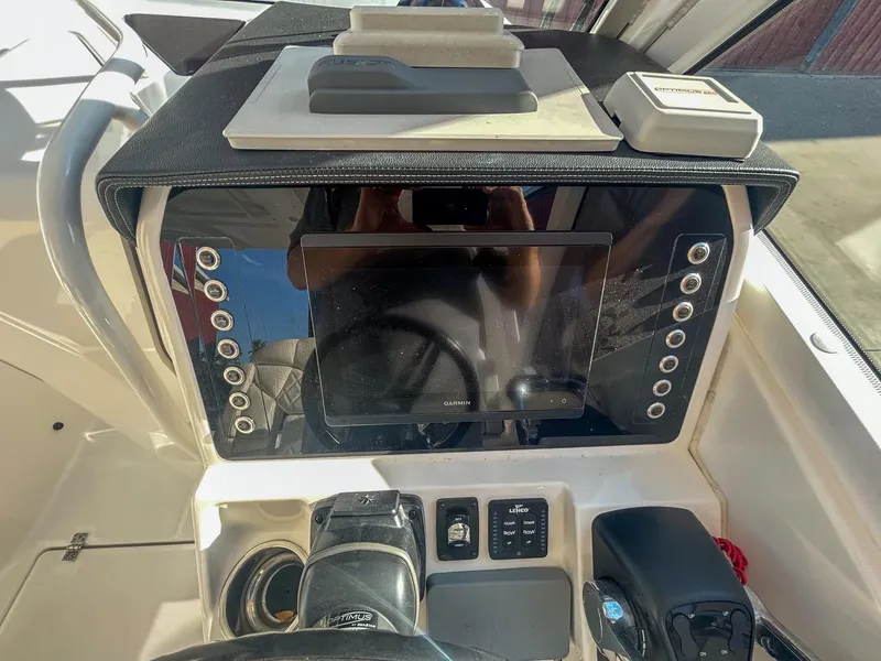 Slide: The Image of Edgewater 262 CX 2020 boat dashboard with navigation controls and display screen. - 16