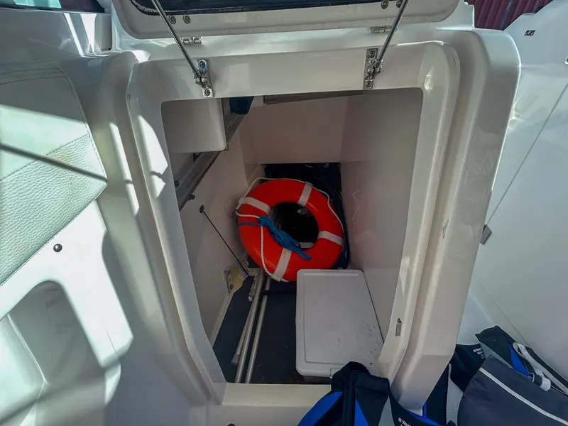 Slide: The Image of Storage compartment in 2020 Edgewater 262 CX boat with life preserver inside. - 17