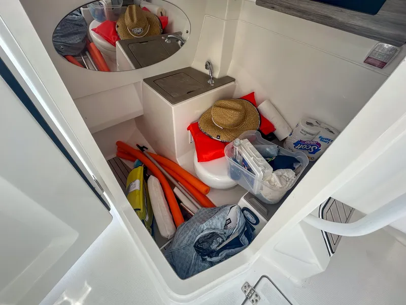 Slide: The Image of 2020 Edgewater 262 CX boat interior with storage items and accessories. - 18