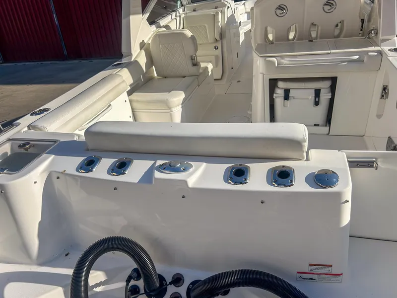 Slide: The Image of 2020 Edgewater 262 CX boat interior with seating and storage compartments. - 6