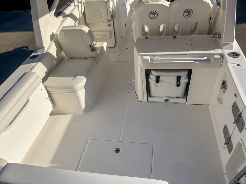 Slide: The Image of 2020 Edgewater 262 CX boat interior with seating and storage compartments. - 7