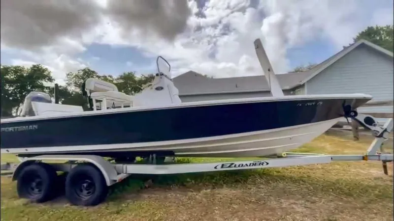 Slide: The Image of 2014 Sportsman TOURNAMENT 214 boat on trailer, parked outdoors under cloudy sky. - 4