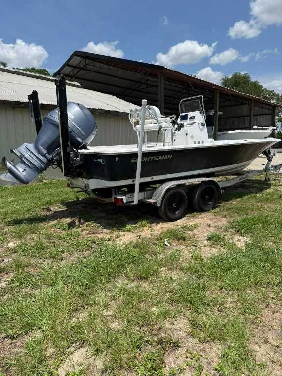 Slide: The Image of 2014 Sportsman TOURNAMENT 214 boat on trailer, parked outdoors under a clear sky. - 5