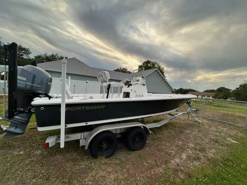 Slide: The Image of 2014 Sportsman TOURNAMENT 214 boat on trailer, parked outdoors under cloudy sky. - 6