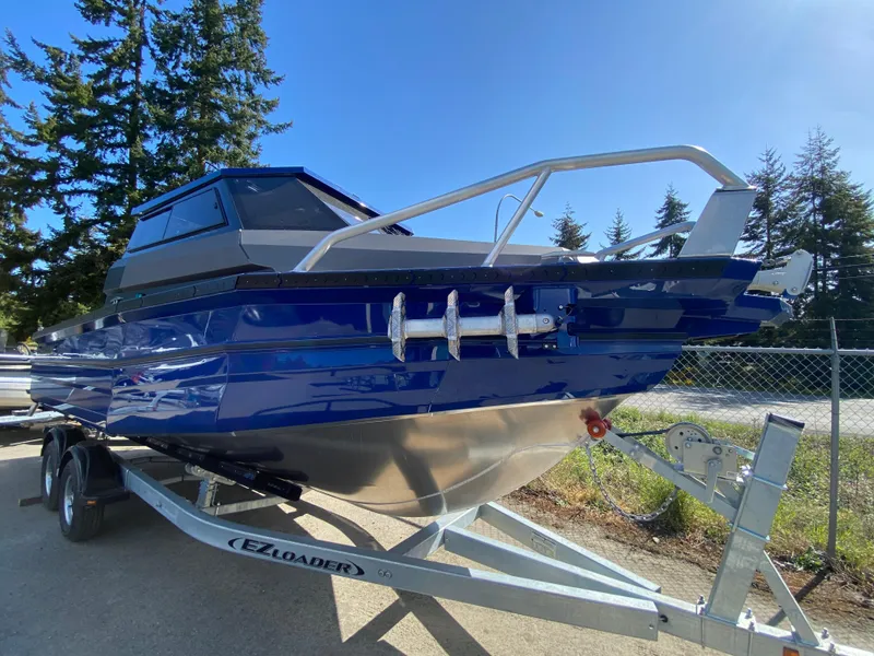 The Image of 2025 Stabicraft 2350 Supercab boat on trailer, blue exterior, parked outdoors. - 0
