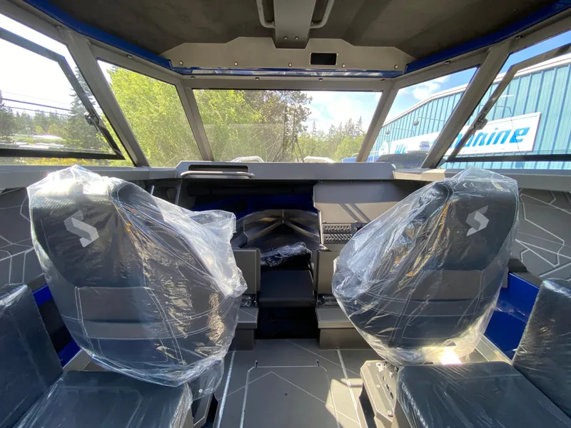 Slide: The Image of 2025 Stabicraft 2350 Supercab interior with protective seat covers, showcasing modern design and spacious cabin. - 11