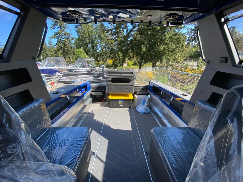 Slide: The Image of 2025 Stabicraft 2350 Supercab interior with seating, storage, and outdoor view. - 14