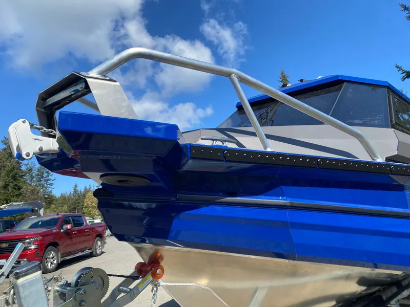 Slide: The Image of 2025 Stabicraft 2350 Supercab boat with blue exterior, parked outdoors under a clear sky. - 3