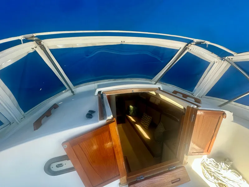 Slide: The Image of 1979 O'Day Center Cockpit sailboat with open cabin doors, showcasing interior seating. - 10