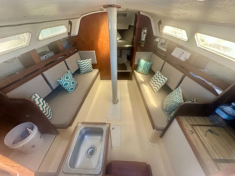 Slide: The Image of 1979 O'Day Center Cockpit interior with seating, cushions, and a small sink. - 11