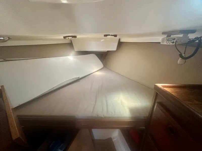 Slide: The Image of 1979 O'Day Center Cockpit interior cabin with bed and storage compartments. - 14