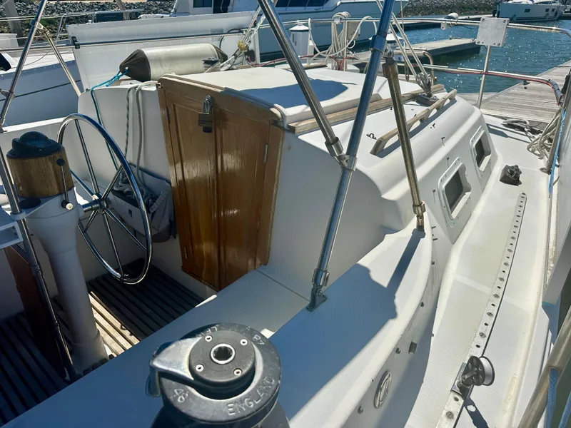 Slide: The Image of 1979 O'Day Center Cockpit sailboat with wooden door and steering wheel, docked at marina. - 16