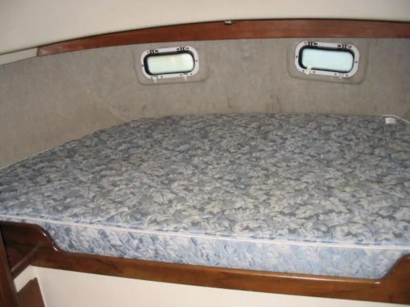 Slide: The Image of 1979 O'Day Center Cockpit interior with a cushioned bed and small windows. - 17