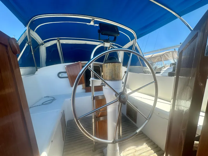 Slide: The Image of 1979 O'Day Center Cockpit sailboat with blue canopy and steering wheel. - 19