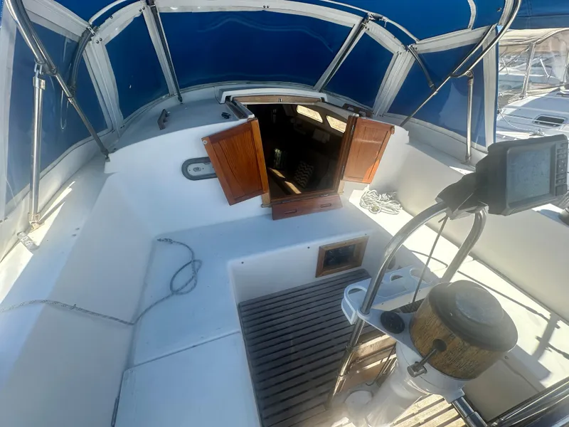 Slide: The Image of 1979 O'Day Center Cockpit sailboat interior with blue canopy and wooden accents. - 25
