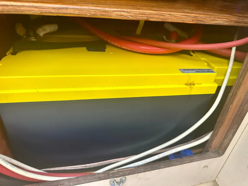 Slide: The Image of Yellow battery in 1979 O'Day Center Cockpit boat with red and white cables. - 26
